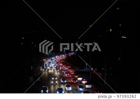 Kyiv, Ukraine - December 16, 2022: Blackout in the Ukrainian capital Kyiv. Capital streets without street lighting. Only the lights of passing cars are visible 97393262