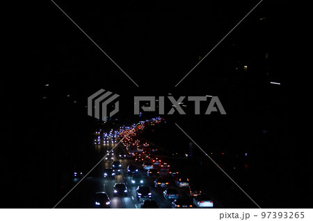 Kyiv, Ukraine - December 16, 2022: Blackout in the Ukrainian capital Kyiv. Capital streets without street lighting. Only the lights of passing cars are visible 97393265