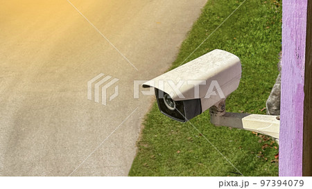 Old and dirty surveillance camera but it is still active installed at a house to provide safety for its inhabitants  97394079