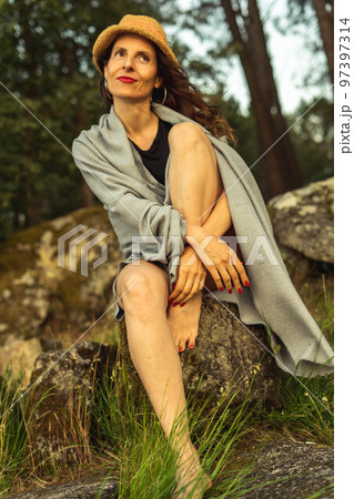 woman sitting on a stone 97397314