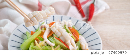 Stir-fried neritic squid with celery. Delicious homemade seafood with vegetable meal. 97400979