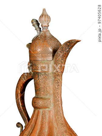 A close up of an antique copper jug with artistic chasing and engraving on a white background A close up of an antique copper jug with artistic chasing and engraving on a white background 97405628