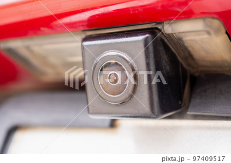 Red car rear view camera close up for parking assistance Red car rear view camera close up for parking assistance 97409517