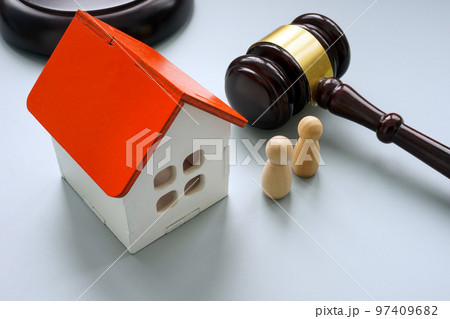 Model of house with two figures and gavel. Separation or inheritance concept. 97409682