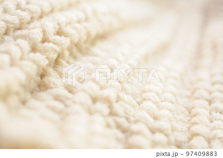 closeup beige knitted woolen fabric texture background closeup beige knitted woolen fabric texture background 97409883