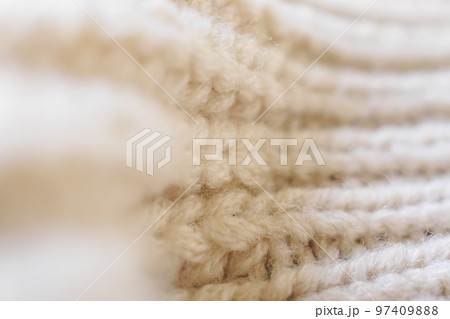 closeup beige knitted woolen fabric texture background 97409888