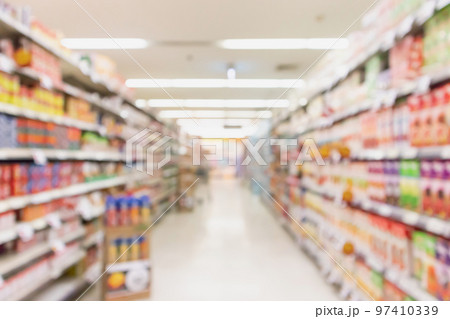 Empty supermarket aisle with product on shelves blurred background Empty supermarket aisle with product on shelves blurred background 97410339