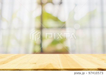 Empty wood table top with blur white curtain window and green garden background for product display template Empty wood table top with blur white curtain window and green garden background for product display template 97410573