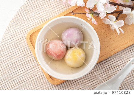 Colored glaze style big tangyuan with cherry blossom flower and syrup soup. 97410828