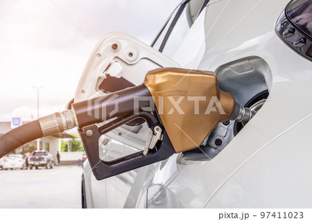 White car refueling at petrol gas station White car refueling at petrol gas station 97411023