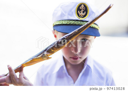 Dry fish needle against a blurred background of a boy fisherman.; Dry fish needle against a blurred background of a boy fisherman.; 97413028