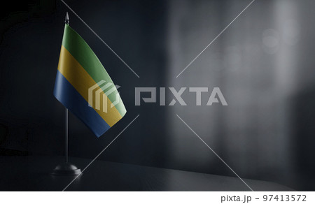 Small national flag of the Gabon on a black background 97413572