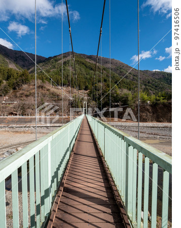 冬晴れの山梨県丹波山村の丹波川にかかるやまびこ橋 97416506