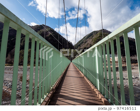 冬晴れの山梨県丹波山村の丹波川にかかるやまびこ橋 97416511