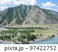 Emerald water at the bend of a mountain river among the rocky mountains under a blue sky. Siberia, Russia 97422752