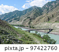 old suspension bridge over a mountain river 97422760