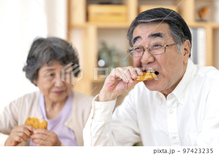 固い食べ物が食べづらいシニア男性 97423235