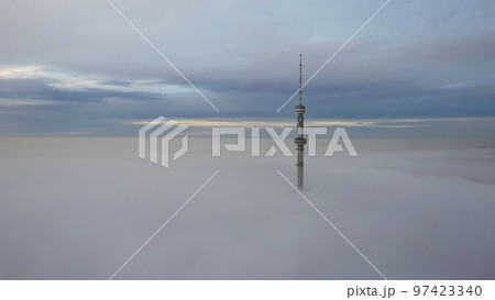 The TV tower looks out of the clouds at sunset. The TV tower looks out of the clouds at sunset. 97423340