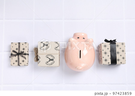 Concept of Christmas finance with piggy bank, top view Concept of Christmas finance with piggy bank, top view 97423859