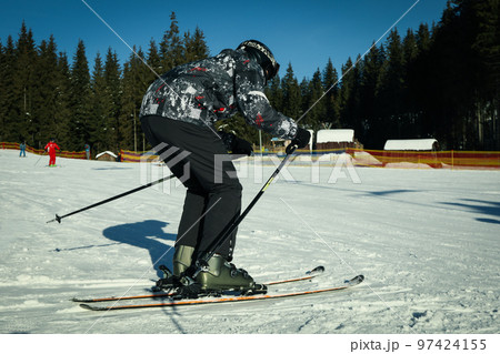 Skier outdoor on ski slope, ski season concept Skier outdoor on ski slope, ski season concept 97424155