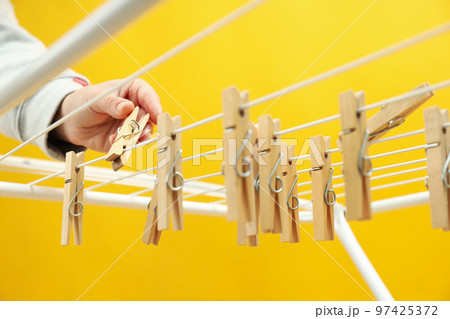Clothespins hanging on drying rack, close up 97425372