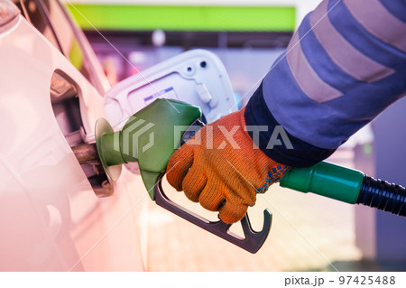Refueling the car at a gas station fuel pump 97425488
