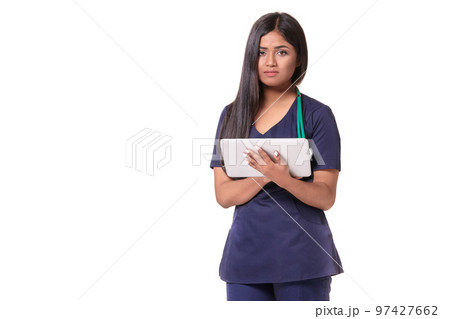 Young pretty doctor with a stethoscope and a medical history in her arms Young pretty doctor with a stethoscope and a medical history in her arms 97427662