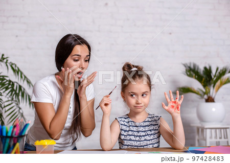 Happy family. Mother and daughter together paint. 97428483