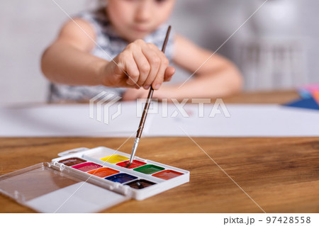 Education, school, art and painting concept - Little girl draws paints Education, school, art and painting concept - Little girl draws paints 97428558