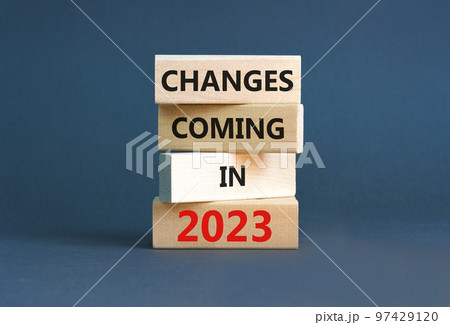 Changes coming in 2023 symbol. Concept word Changes coming in 2023 on wooden blocks. Beautiful grey table grey background. Business and changes coming in 2023 concept. Copy space. 97429120