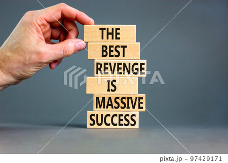 Revenge or success symbol. Concept words The best revenge is massive success on wooden blocks. Bussinesman hand. Beautiful grey background. Business and revenge or success concept. Copy space. 97429171
