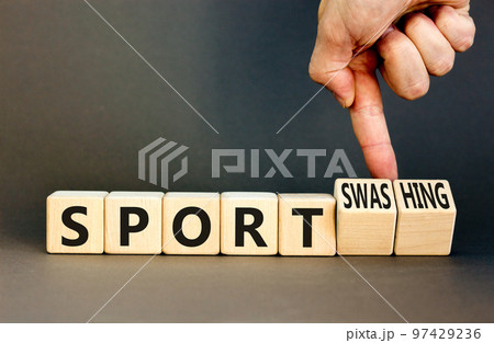 Sport or sportswashing symbol. Concept words Sport and Sportswashing on wooden cubes. Businessman hand. Beautiful grey table grey background. Business sport sportswashing concept. Copy space. Sport or sportswashing symbol. Concept words Sport and Sportswashing on wooden cubes. Businessman hand. Beautiful grey table grey background. Business sport sportswashing concept. Copy space. 97429236