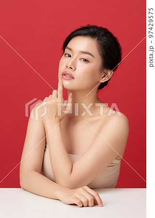 Beautiful young asian woman with clean fresh skin on red background, Face care, Facial treatment, Cosmetology, beauty and spa, Asian women portrait. 97429575