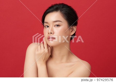 Beautiful young asian woman with clean fresh skin on red background, Face care, Facial treatment, Cosmetology, beauty and spa, Asian women portrait. Beautiful young asian woman with clean fresh skin on red background, Face care, Facial treatment, Cosmetology, beauty and spa, Asian women portrait. 97429576