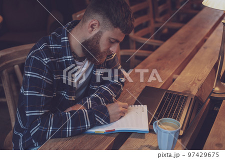 Casual business man or freelancer planning his work on notebook, Casual business man or freelancer planning his work on notebook, 97429675
