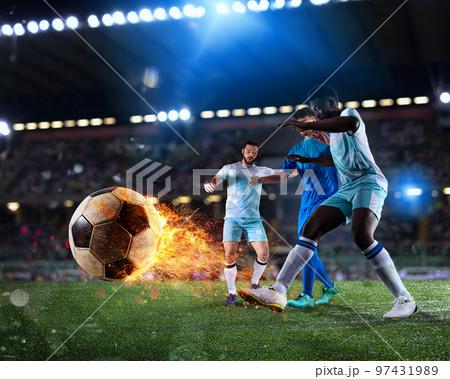 Football scene with competing football players at the full stadium with a fireball Football scene with competing football players at the full stadium with a fireball 97431989