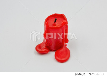 red candle stub closeup on white 97436007