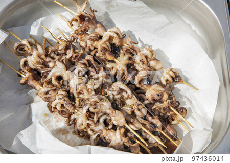 Grilled cuttlefish closeup on wooden skewers 97436014