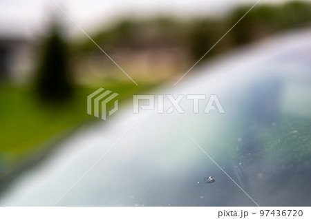 Chip in the glass windshield of a vehicle. 97436720