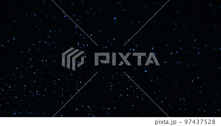 Sparkling background. Bokeh glitter texture. Night sky stars. Defocused blue color light reflection on dark black abstract free space wallpaper. Sparkling background. Bokeh glitter texture. Night sky stars. Defocused blue color light reflection on dark black abstract free space wallpaper. 97437528