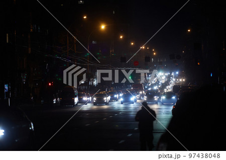 Kyiv, Ukraine - December 16, 2022: Blackout in the Ukrainian capital Kyiv. Capital streets without street lighting. Only the lights of passing cars are visible Kyiv, Ukraine - December 16, 2022: Blackout in the Ukrainian capital Kyiv. Capital streets without street lighting. Only the lights of passing cars are visible 97438048