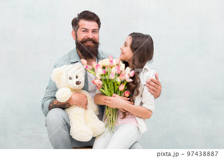 Wishing happy anniversary. Happy family celebrate anniversary. Father and daughter hold tulips and toy. Fathers day. Womens day. Birthday anniversary. Holiday celebration. International childrens day 97438887