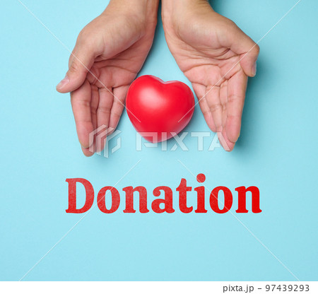 Female hands holds red heart, blue background. Love and donation concept 97439293