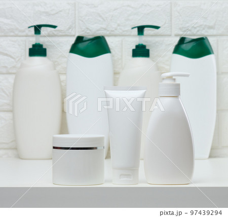 White plastic jars and tubes for liquid cosmetics on a white background. Branding, advertising 97439294