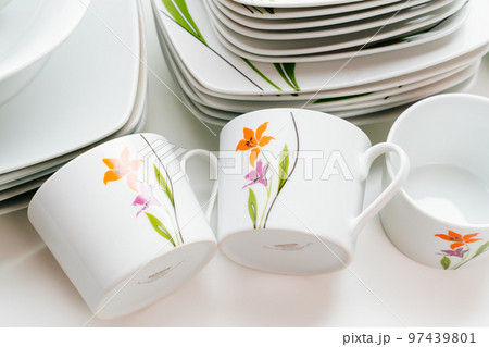 cups and plates with the image of flowers on a white table cups and plates with the image of flowers on a white table 97439801