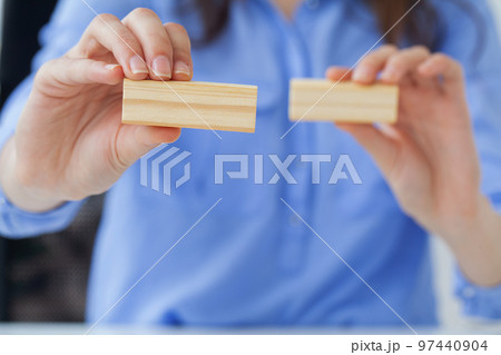 Woman hand of engineer playing a wood block 97440904
