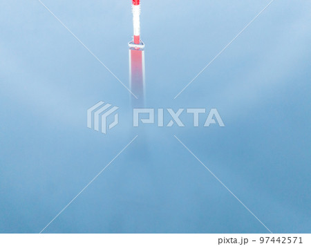Aerial drone top view of the Riga TV Tower in Latvia. Highest TV tower in Europe over the clouds. 97442571