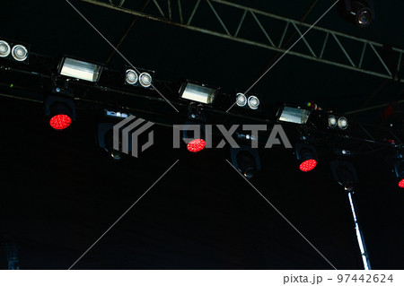 Defocus many red spotlights that illuminate the stage at a concert with fog. spotlights on a theatre stage on black background. Out of focus Defocus many red spotlights that illuminate the stage at a concert with fog. spotlights on a theatre stage on black background. Out of focus 97442624