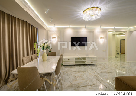 Studio apartment featuring classic kitchen with island as dining area, and tv set at the wall Studio apartment featuring classic kitchen with island as dining area, and tv set at the wall 97442732