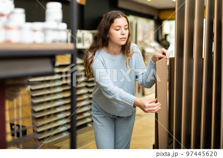 Positive woman choosing flooring in store 97445620